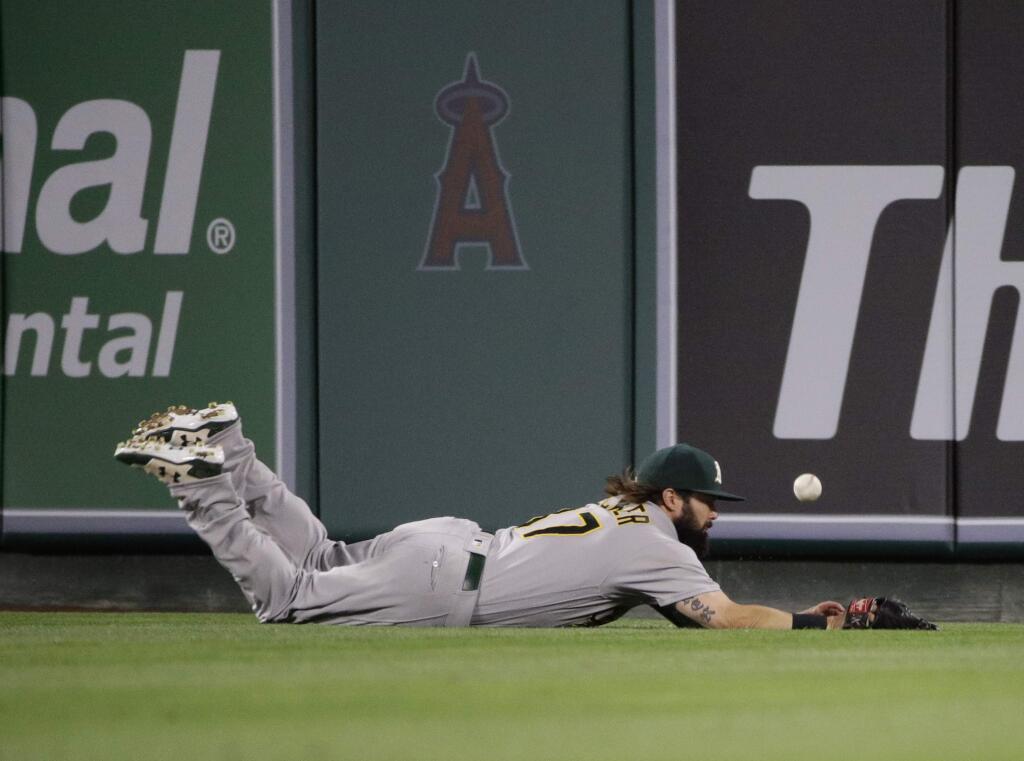 Oakland Athletics center fielder Jaff Decker misses a double by the Los Angeles Angels' Martin Maldonado during the second inning Wednesday, April 26, 2017, in Anaheim. (AP Photo/Jae C. Hong)