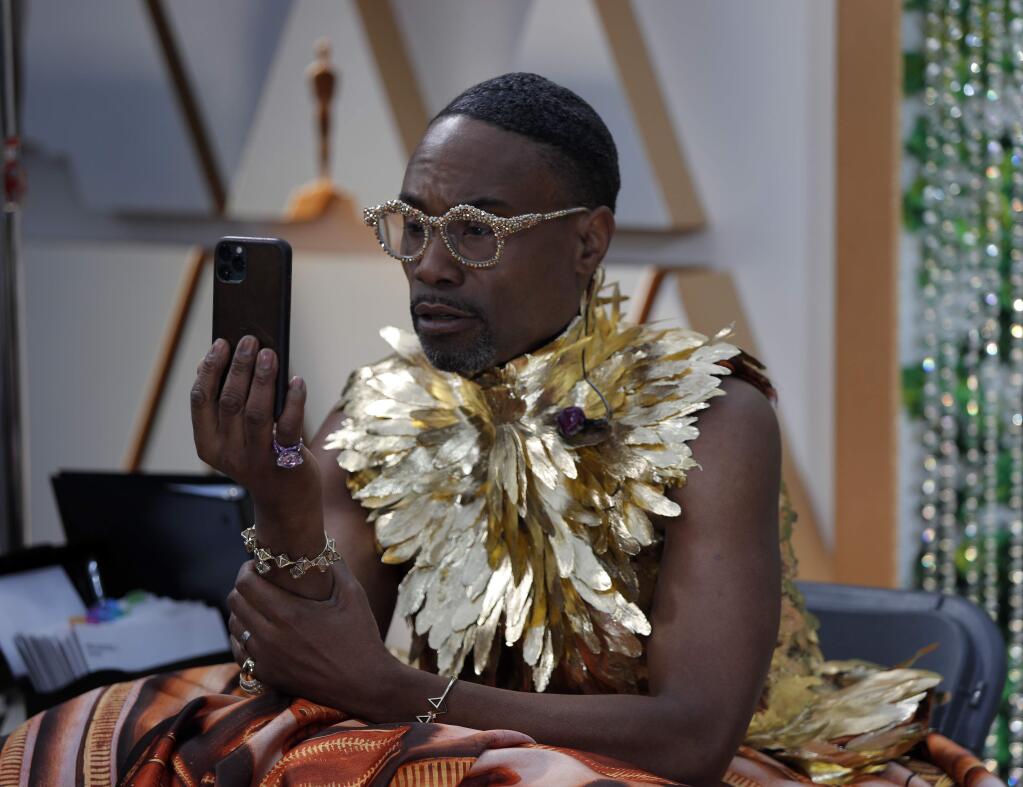 Billy Porter takes a photo on the red carpet at the Oscars on Sunday, Feb. 9, 2020, at the Dolby Theatre in Los Angeles. (AP Photo/John Locher)