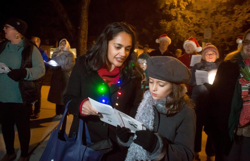 Kinna Crocker and her daughter Sloane, 8, serenade Walnut Park in Petaluma, Calif. with Christmas carols Friday, December 23, 2016. Members of the First Presbyterian Church organized the event. (Jeremy Portje / For The Press Democrat)