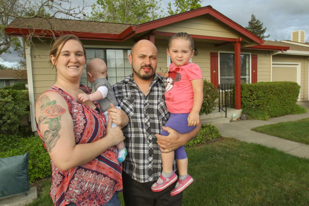 The Gutierrez family, Jason, Cathy Killinger, and their children Gabriela 'Gabby', 2 years, and Julian, 4 months, in front of their Petaluma home that they are in the process of being evicted from. (SCOTT MANCHESTER/ARGUS-COURIER STAFF)