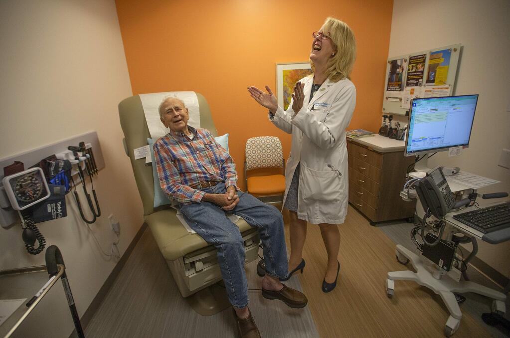 Dr. Catherine Gutfreund laughs at a joke told by patient Robert Farrell at the new Kaiser Medical Building on Mercury Way in Southwest Santa Rosa. (photo by John Burgess/The Press Democrat)