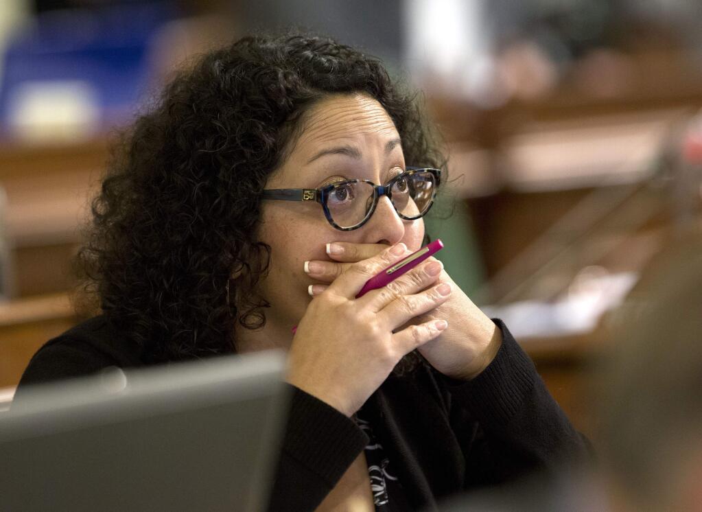 FILE - In this Aug. 18, 2016 file photo, Assemblywoman Cristina Garcia, D-Bell Gardens, watches as the votes are posted for a measure before the Assembly in Sacramento, Calif. California law requires lawmakers and legislative staff attend sexual harassment training every two years, just as private-sector employees in supervisory roles do. 'Some people do take it seriously, and some people are on their phones, some people are cracking jokes,' said Garcia, chair of the Legislative Women's Caucus. 'I would say the large majority of people are not as attentive.' (AP Photo/Rich Pedroncelli, File)