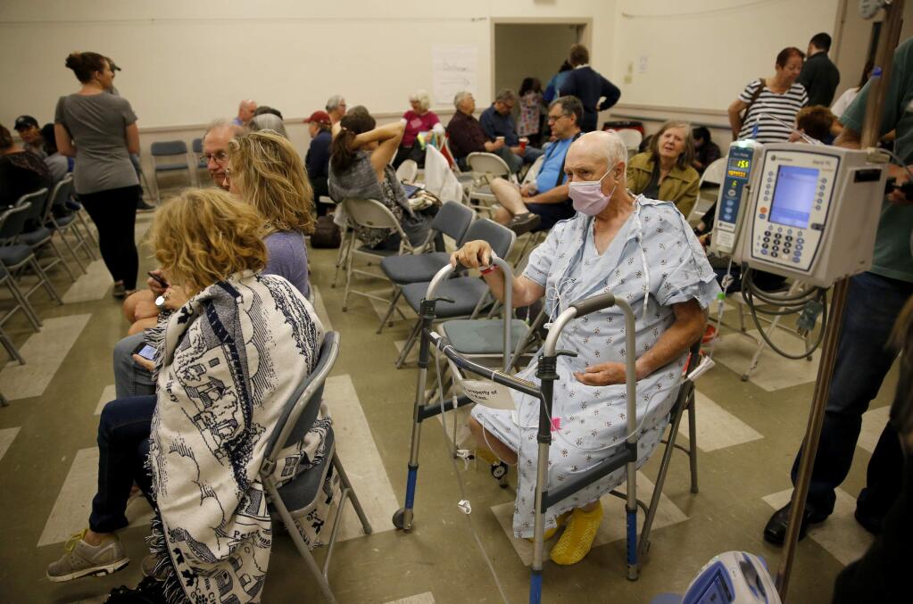 Kaiser patient Chuck Paul sits at the Veterans Memorial Building being used as a evacuation site on Monday, October 9, 2017 in Santa Rosa, California . (BETH SCHLANKER/The Press Democrat)
