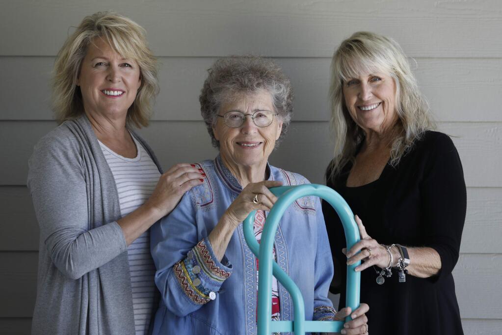 Donna Payne, center, and her daughters Lisa Payne, left, and Belinda Turnbow, right, stand with a hand truck that was recovered from Donna Payne's Fountaingrove home after theTubbs fire and then repainted in a color similar to Tiffany blue. Photo taken on Saturday, June 16, 2018 in Cotati, California . (BETH SCHLANKER/The Press Democrat)