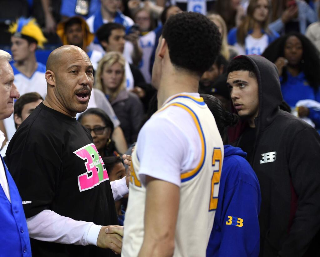 FILE - In this March 4, 2017, file photo, UCLA guard Lonzo Ball, right, shakes hands with his father LaVar following an NCAA college basketball game against Washington State in Los Angeles. UCLA won 77-68. LaVar Ball's Big Baller Brand unveiled a signature shoe for Lonzo Ball on May 4, 2017 with a price tag of $495 a pair. (AP Photo/Mark J. Terrill, File)