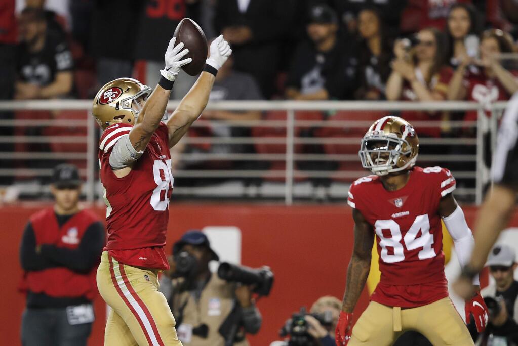 San Francisco 49ers tight end George Kittle, left, celebrates next to wide receiver Kendrick Bourne after a touchdown against the Oakland Raiders during the second half in Santa Clara, Thursday, Nov. 1, 2018. (AP Photo/John Hefti)