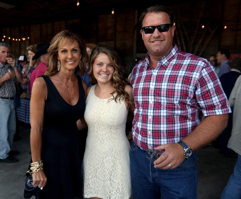 Theresa Dutton, left, Jordan Dutton, center, and Steve Dutton, right, attend the BBQ, Brews and Barn Dance held at Dutton Ranch, Saturday, May 30, 2015. (Crista Jeremiason / The Press Democrat)