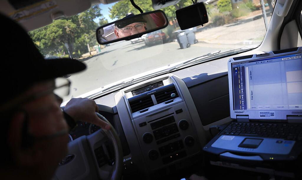 Larry Tait, the parking enforcement supervisor for Santa Rosa, maneuvers his camera-laden vehicle near the Sonoma County Fairgrounds as he tests out new software to help in parking violation enforcement on Tuesday, July 11, 2017. (KENT PORTER/ PD)