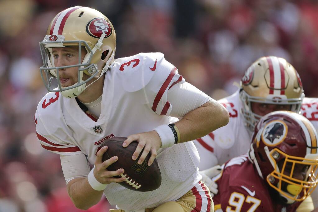 San Francisco 49ers quarterback C.J. Beathard scrambles with the ball during the first half against the Washington Redskins in Landover, Md., Sunday, Oct. 15, 2017. (AP Photo/Mark Tenally)