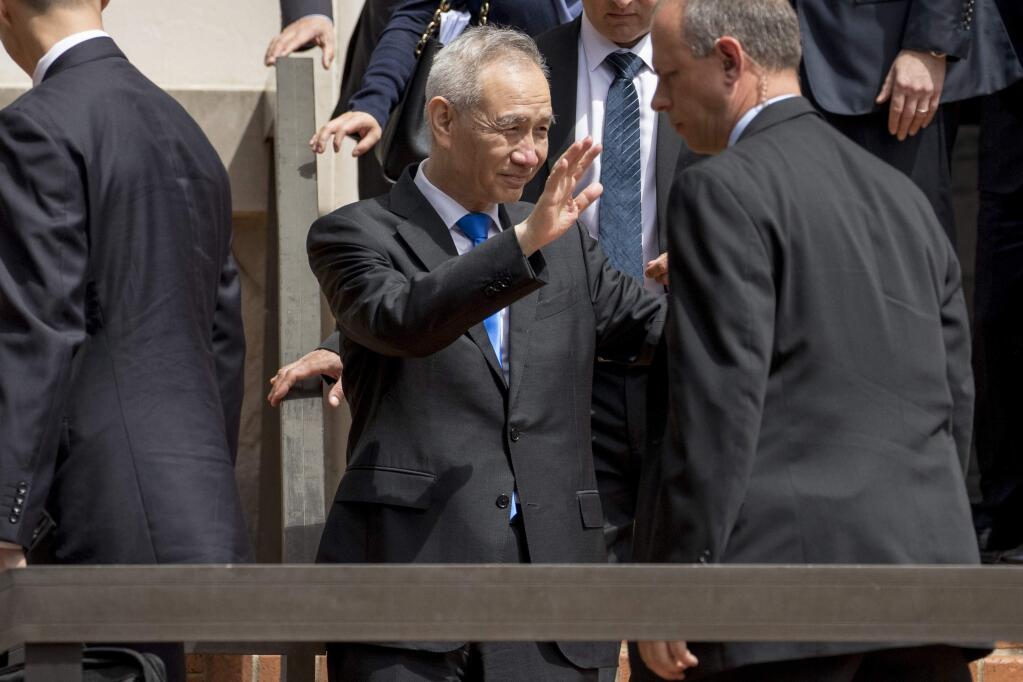 Chinese Vice Premier Liu He waves to members of the media as he departs the Office of the United States Trade Representative in Washington, Friday, May 10, 2019. (AP Photo/Andrew Harnik)