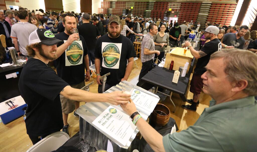 Crista Jeremiason / The Press DemocratMatt Joseph, left, serves beer Pat Power, right, of Petaluma while Nick Gwilliam, second from left and John Ramsey, third from left, watch during the Sonoma County Home Brewer's Competition held at Petaluma's Veterans Memorial Building, Saturday, May 23, 2015. Brewers Joseph, Gwilliam and Ramsey all of Windsor collaborated on the brew. (CRISTA JEREMIASON / The Press Democrat)
