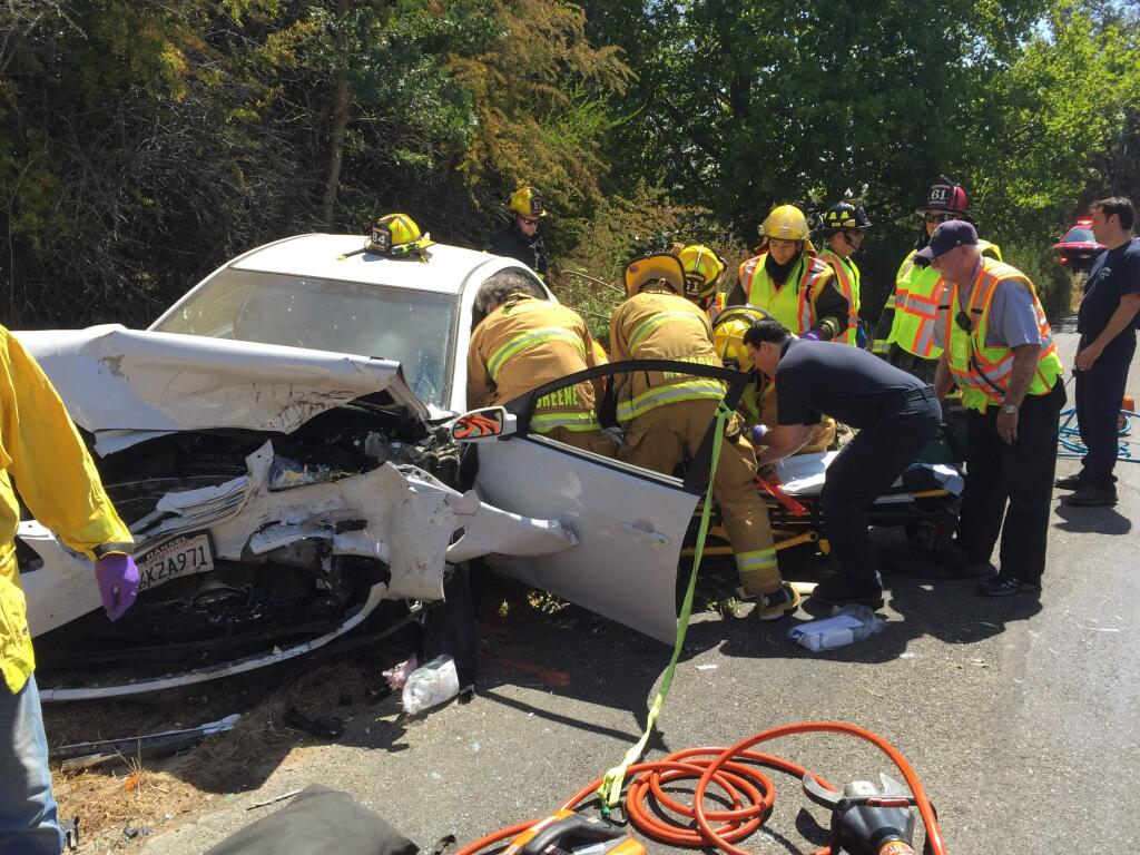 Graton firefighters work to extract a person trapped in their car following a head-on collision on Mill Station Road. (Graton Fire)