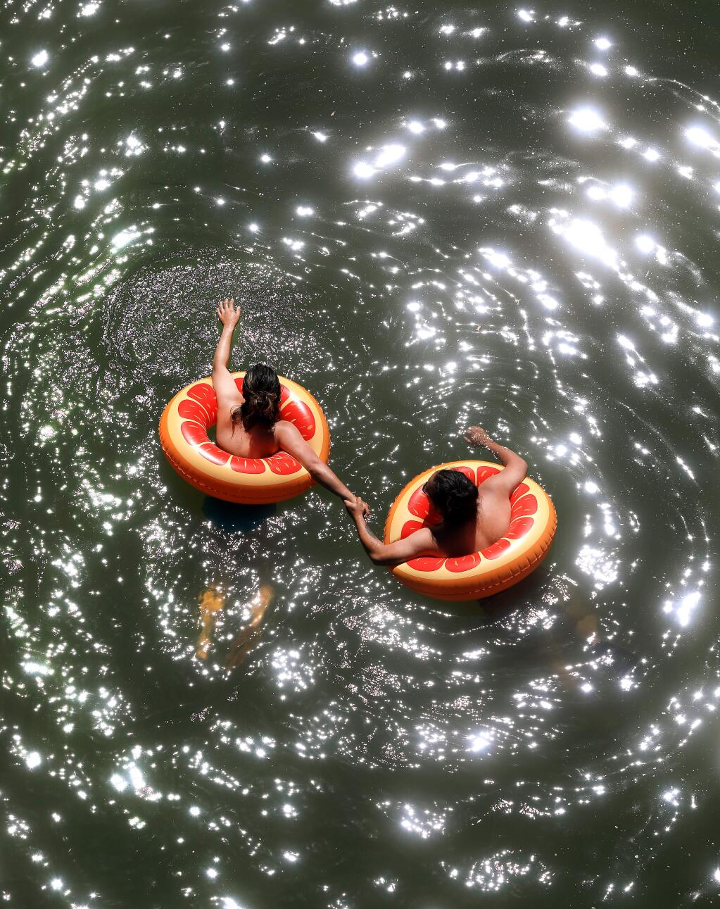 Oakland residents Jude Bermeo, left, and Christine Olivo float down the Russian River in Monte Rio on Tuesday, June 4, 2019 in Monte Rio. Click through for ideas on ways to be the heat. (KENT PORTER/ PD)