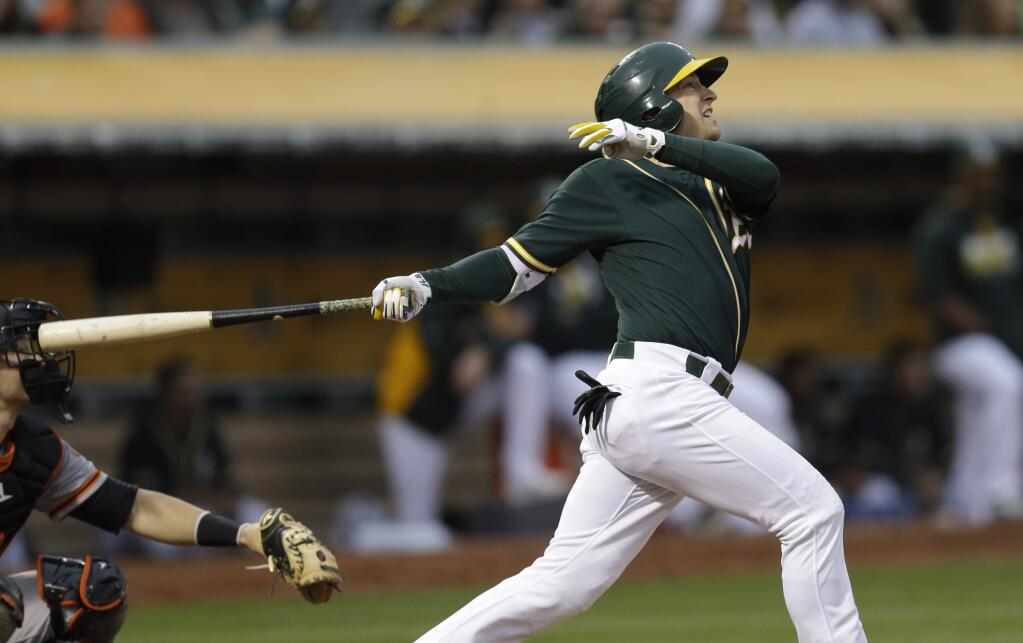 Oakland Athletics' Jed Lowrie watches his two-run home run hit off San Francisco Giants pitcher Jake Peavy in the third inning Wednesday, June 29, 2016, in Oakland. (AP Photo/Ben Margot)