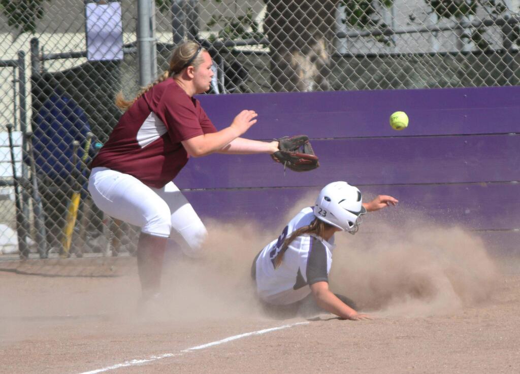 DWIGHT SUGIOKA/FOR THE ARGUS-COURIERPetaluma's Grace Ghirardelli slides home ahead of the throw to Piner pitcher Hana Suppus during T-Girls championship-clinching victory.