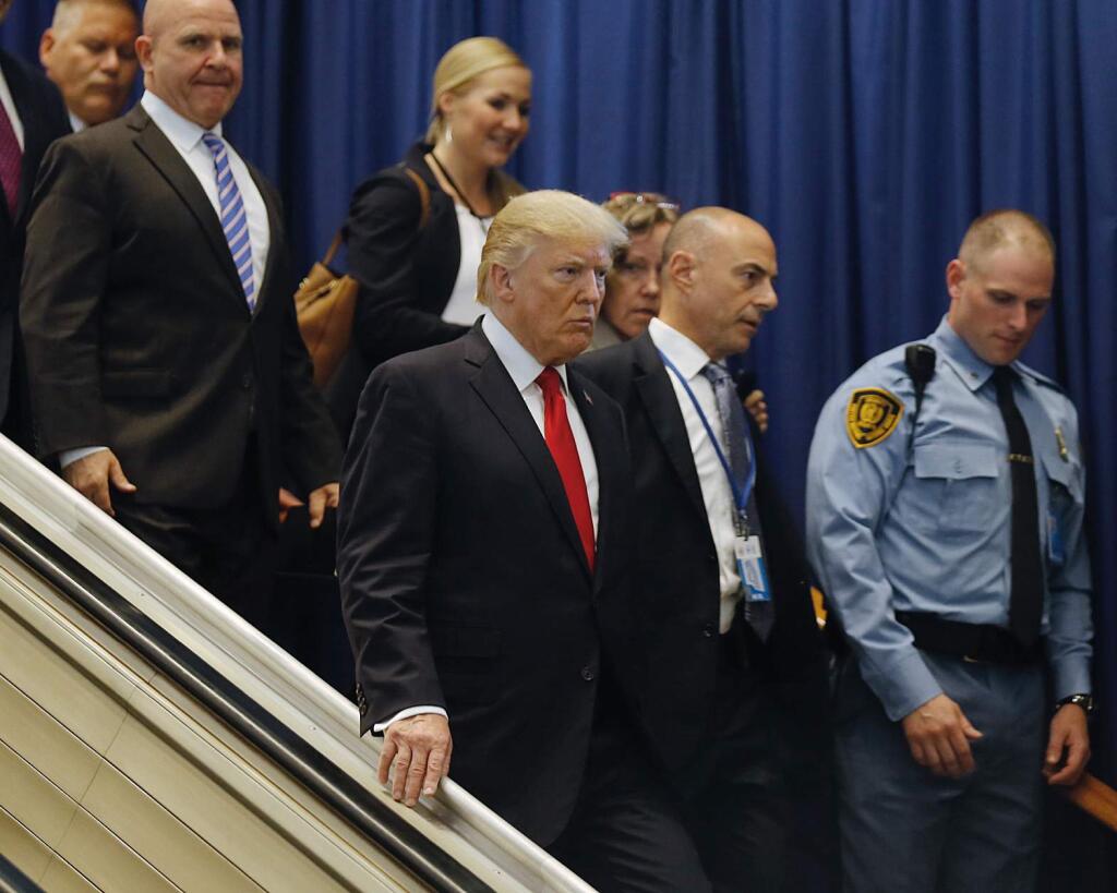 President Donald Trump, center, leaves after addressing a meeting at the United Nations, Monday Sept. 18, 2017 at U.N. headquarters. (AP Photo/Bebeto Matthews)