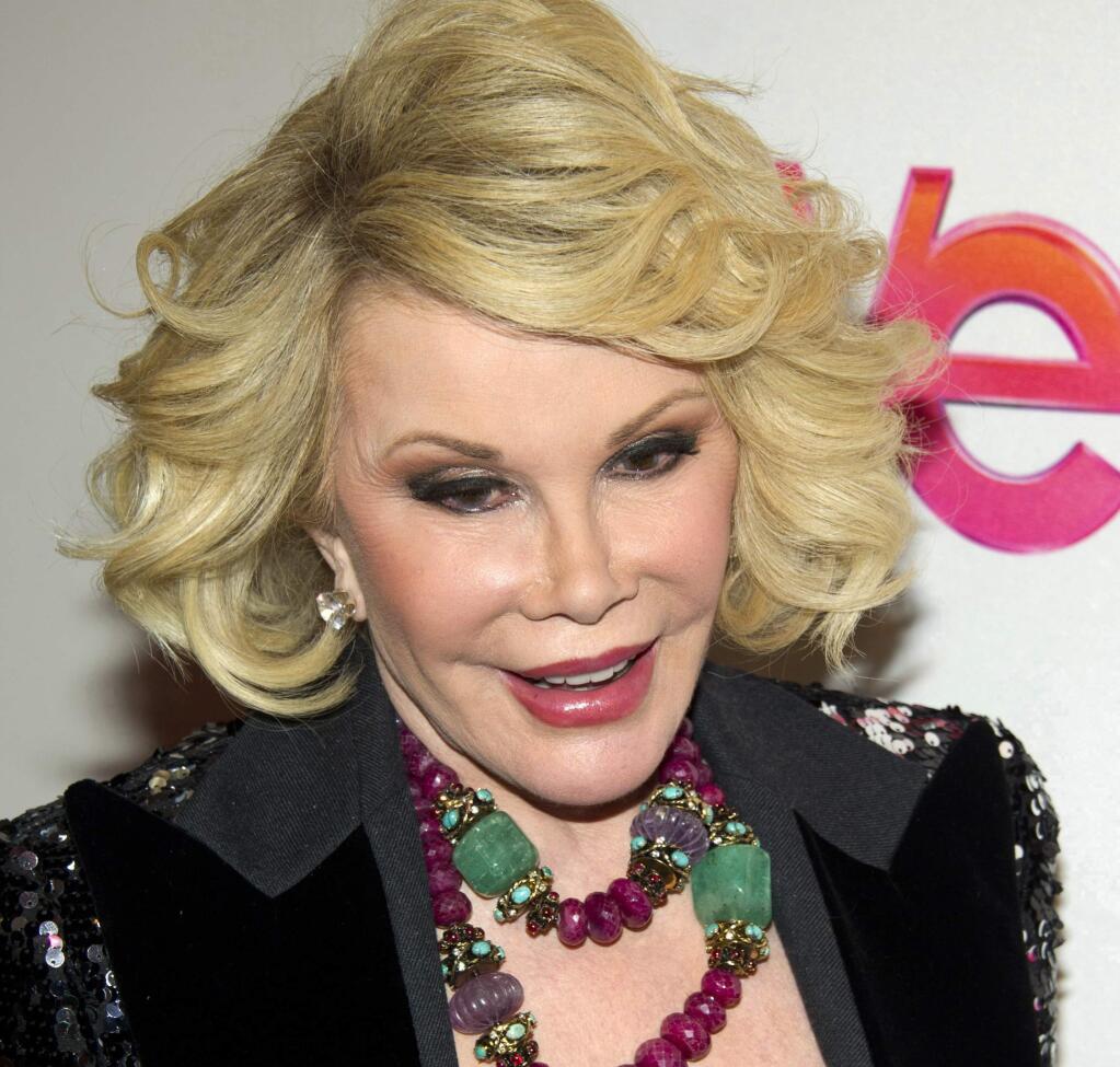 In this Jan. 19, 2012, file photo, Joan Rivers attends a screening of the Season 2 premiere of WE TV's 'Joan & Melissa: Joan Knows Best?' in New York. Two police officials say Rivers has been rushed in cardiac arrest from a doctor's office to a New York City hospital, Thursday, Aug. 28, 2014. (AP Photo/Charles Sykes, File)