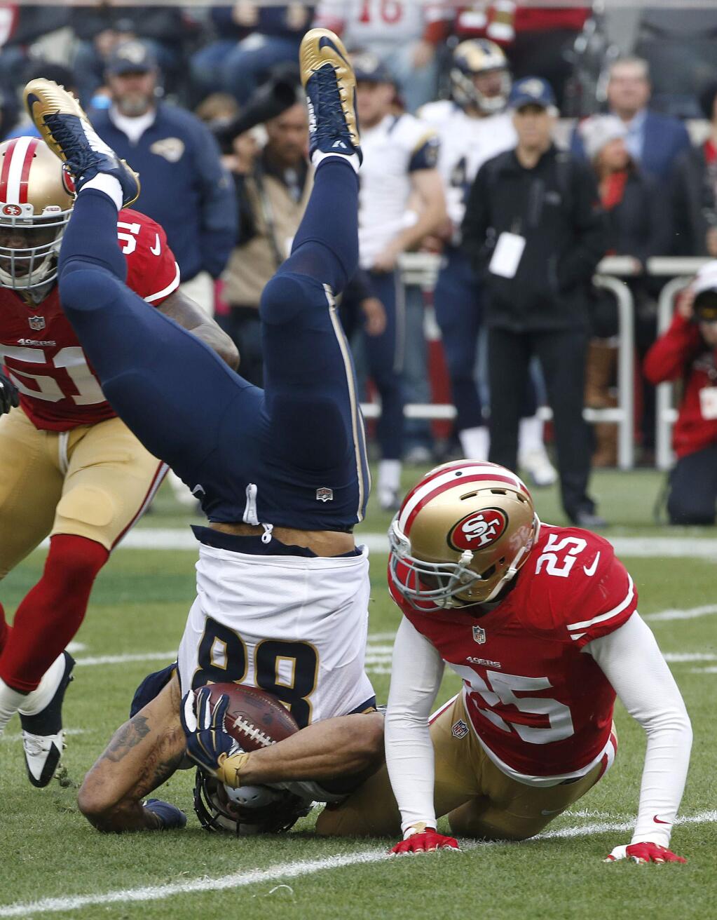 St. Louis Rams tight end Lance Kendricks (88) is tackled by San Francisco 49ers strong safety Jimmie Ward (25) during the first half of an NFL football game in Santa Clara, Calif., Sunday, Jan. 3, 2016. (AP Photo/Tony Avelar)