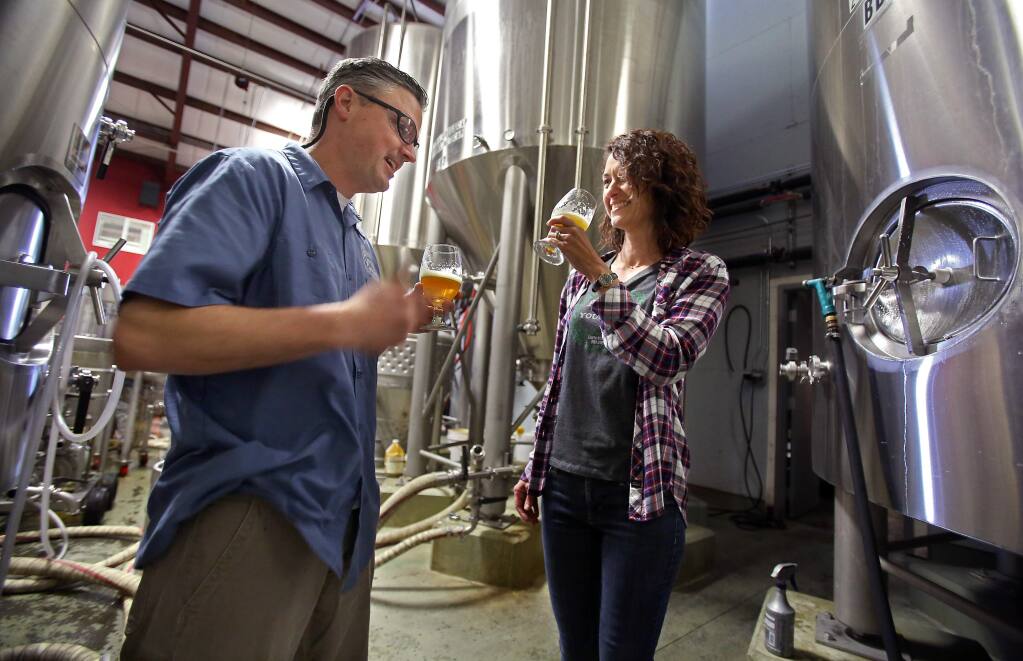 Russian River Brewing Company co-owners Vinnie and Natalie Cilurzo sample Pliny the Younger at the brewing facility in Santa Rosa on Thursday, February 5, 2015. (Christopher Chung/ The Press Democrat)