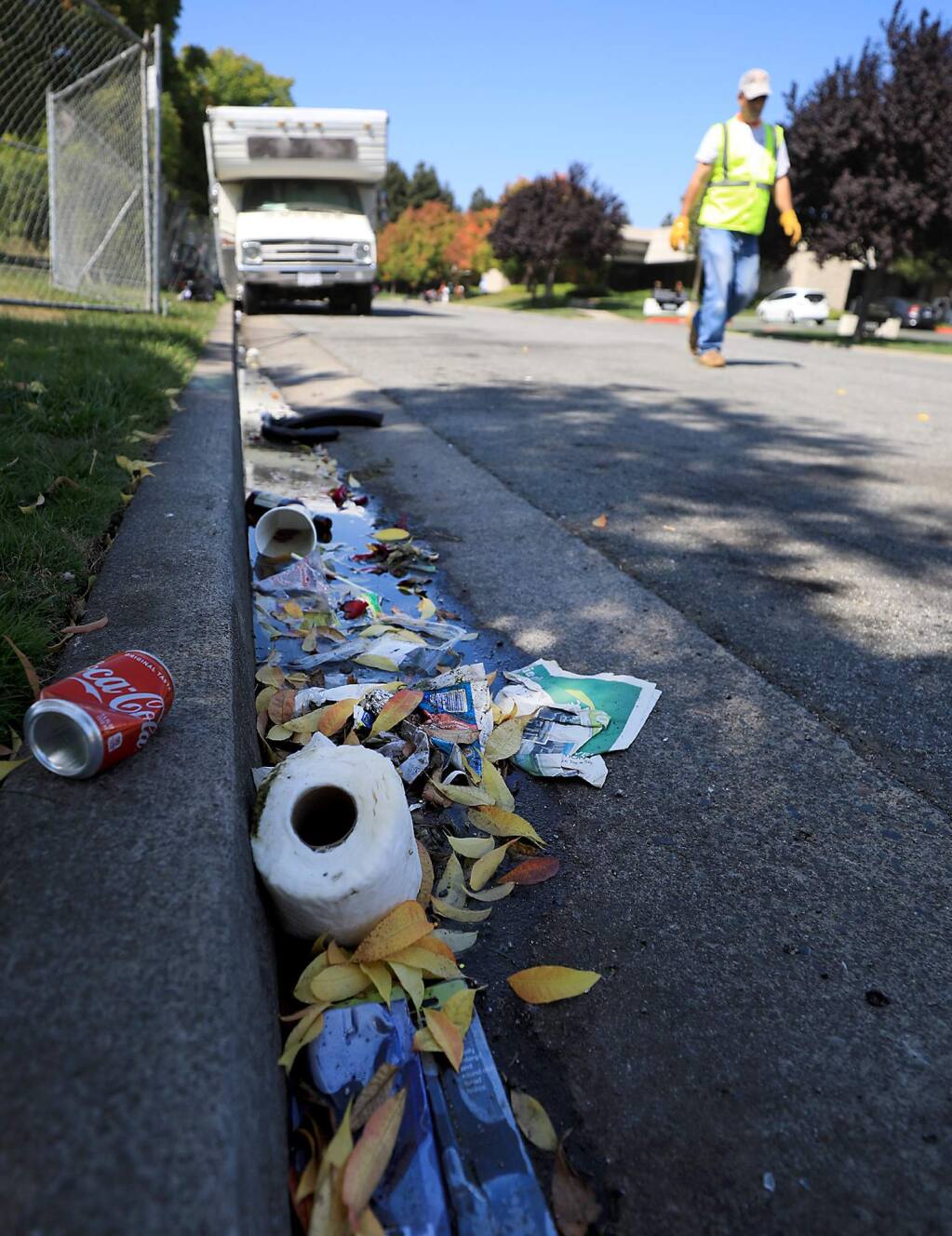 Garbage and debris clog a gutter att Northpoint Corporate Center in Santa Rosa, Wednesday, August 29, 2018. Tent camps and motor homes populate the area. (Kent Porter / The Press Democrat) 2018