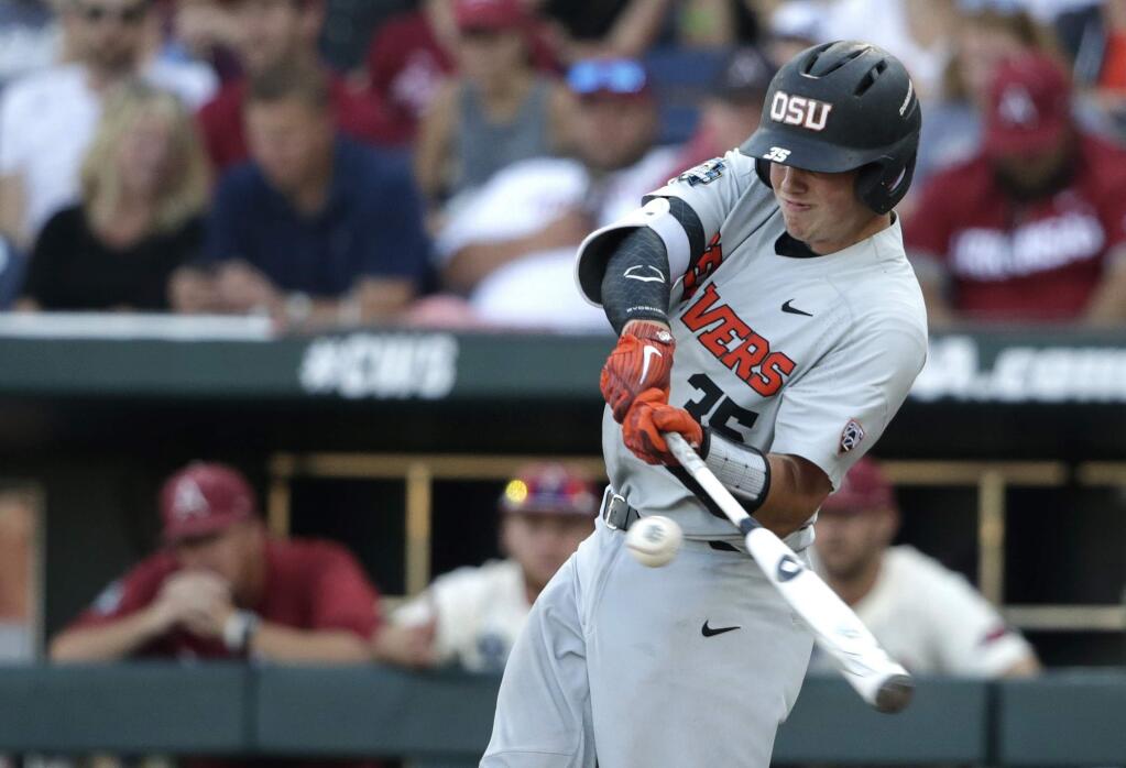 Oregon State's Adley Rutschman singles against Arkansas during the fifth inning of Game 3 of the NCAA College World Series baseball finals, Thursday, June 28, 2018, in Omaha, Neb. (AP Photo/Nati Harnik)