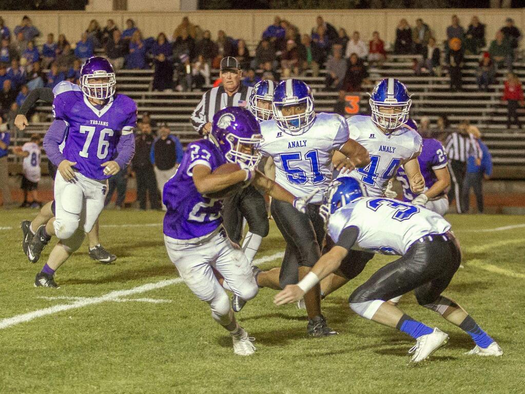 JOHN O'HARA/FOR THE ARGUS-COURIERPetaluma's Dominic Christobal tries to elude Analy tacklers Jacob Ponzo (3), Darrick Smith (51) and Anthony Lepor (44)i. Christobal led the Trojans with 75 rushing yards.