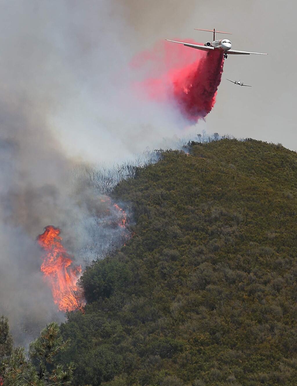 A Cal Fire tanker drops fire retardant near New Long Valley Road in the Pawnee Fire, east ofClearlake Oaks on Monday, June 25, 2018. (Christopher Chung/ The Press Democrat)