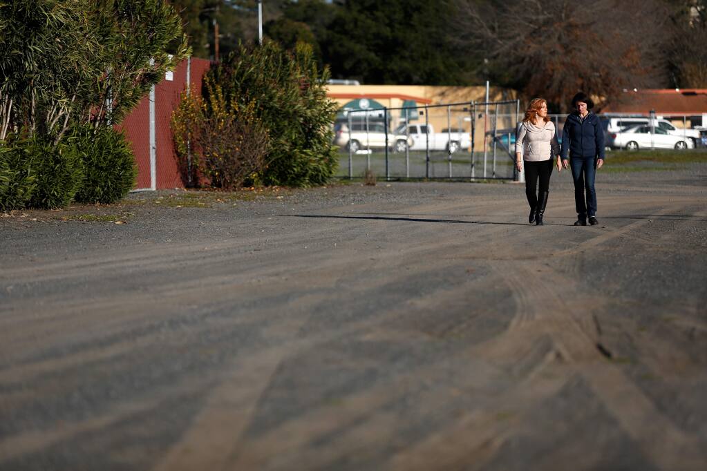 Sonoma County Supervisor Shirlee Zane, left, talks with her staff member Michelle Whitman as they walk through a vacant lot on Fiscal Drive in Santa Rosa where up to 12 tiny homes for homeless people are proposed. (Alvin Jornada / The Press Democrat)