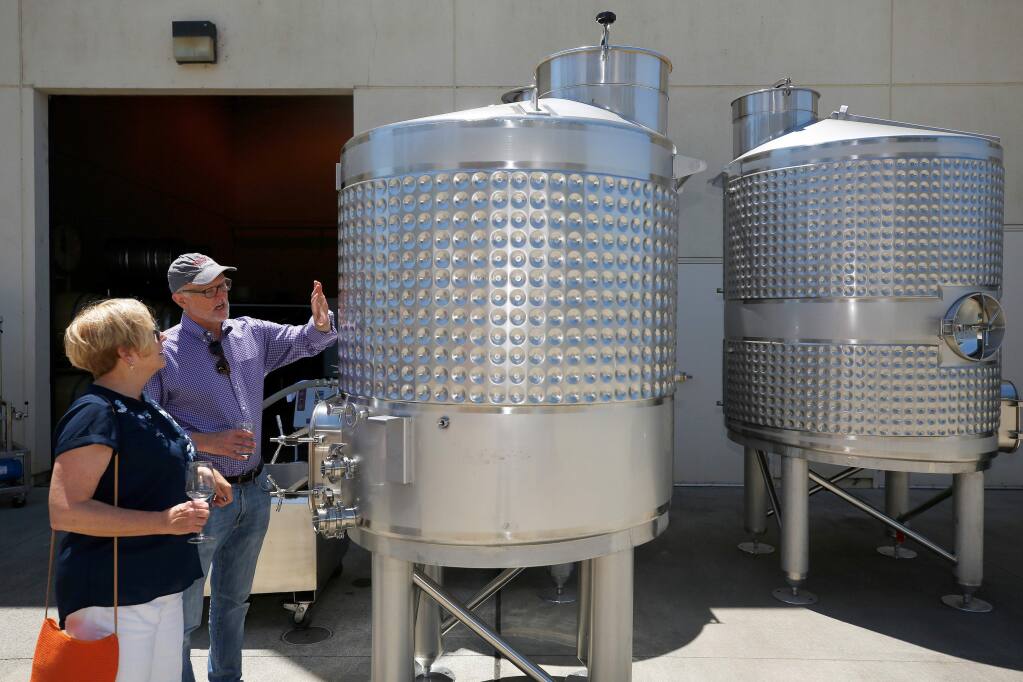 SRJC wine studies program manager Kevin Sea, right, shows SRJC trustee Maggie Fishman the new 900 gallon wine tanks recently acquired by the program through the Strong Workforce state grant, during the Shone Farm Winery Celebration at Santa Rosa Junior College's Shone Farm, in Forestville, California, on Saturday, June 1, 2019. (Alvin Jornada / The Press Democrat)