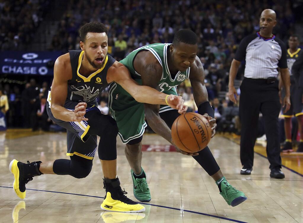 The Boston Celtics' Terry Rozier, right, and the Golden State Warriors' Stephen Curry chase the ball during the second half Saturday, Jan. 27, 2018, in Oakland. (AP Photo/Ben Margot)