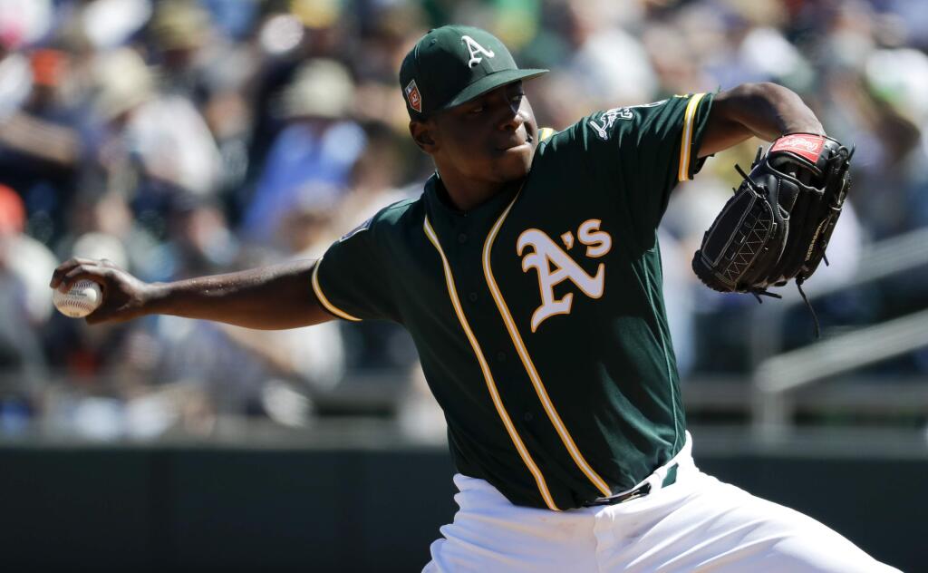 Oakland Athletics starting pitcher Jharel Cotton throws against the San Francisco Giants during the first inning of a spring game in Mesa, Ariz., Monday, March 12, 2018. (AP Photo/Chris Carlson)