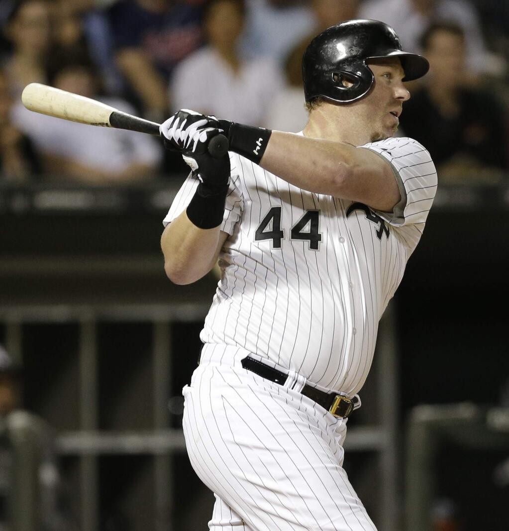 Chicago White Sox's Adam Dunn hits an one-run double against the Cleveland Indians during the third inning of a baseball game in Chicago, Wednesday, Aug. 27, 2014. (AP Photo/Nam Y. Huh)