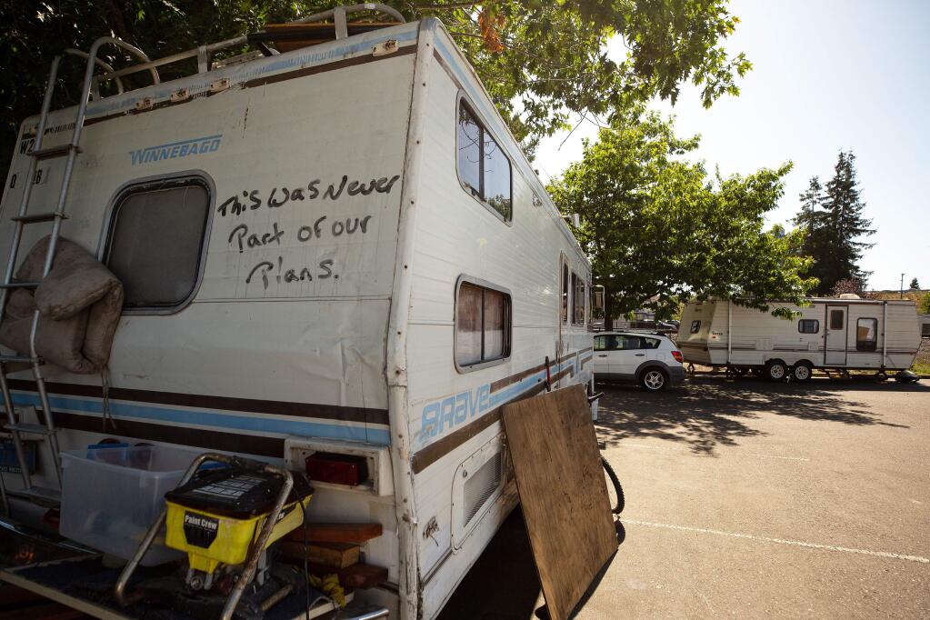 'This was never part of our plans,' is seen written on the back of a homeless person's motor home in a parking lot near the SMART train crossing at Golf Course Drive, in Rohnert Park, California, on Friday, July 19, 2019. (Alvin Jornada / The Press Democrat)