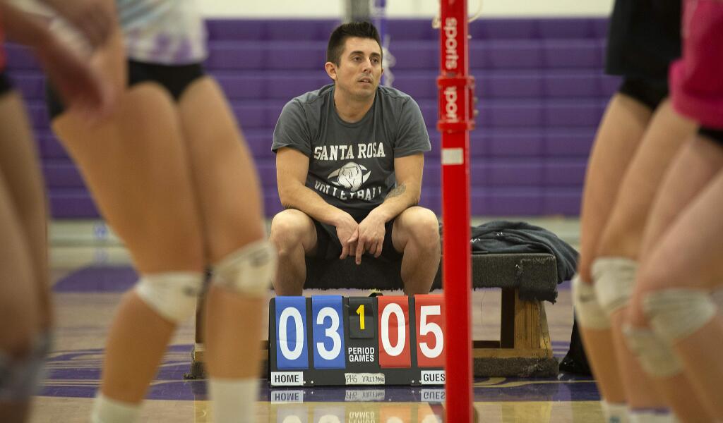 Petaluma High school volleyball coach Ryan Hughes keeps score in a 6-on-6 drill during practice on Tuesday. (John Burgess / The Press Democrat)