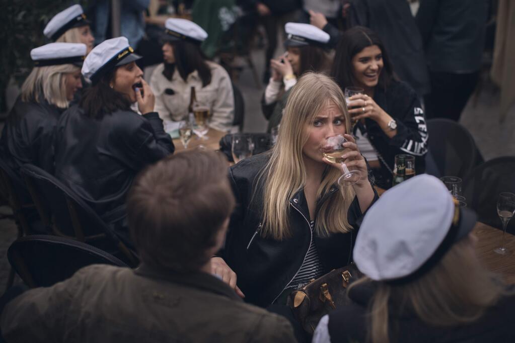 Students celebrating their graduation drink together in the Soderlmalm district of Stockholm, Sweden, April 24, 2020. Sweden declined to order a wholesale lockdown during the coronavirus pandemic, instead trusting its citizens to follow social distancing protocols. Many did not, but the country has fared about the same as other European nations. (Andres Kudacki/The New York Times)