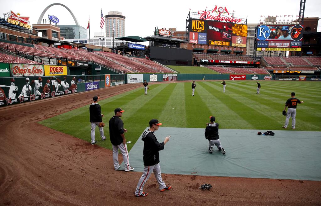 Members of the Giants bullpen warm up before Game 1 of the National League Championship Series at Busch Stadium on Saturday, October 11, 2014 near St. Louis, Missouri. (BETH SCHLANKER/ The Press Democrat)