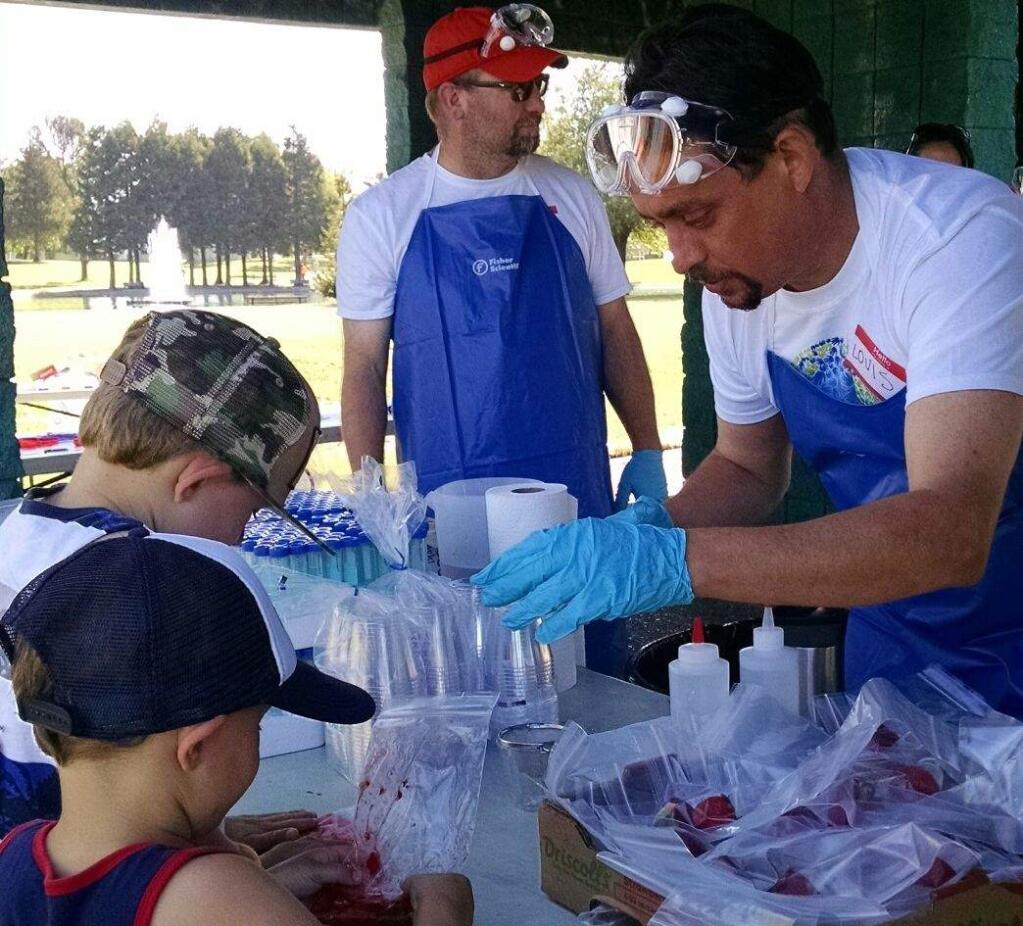 Scientists from Petaluma's Fisher Scientific work with kids at last years STEM expo, part of the annual cancer-fighitng Gran Fondo fundraiser. (PHOTO COURTESY FISHER SCIENTIFIC)