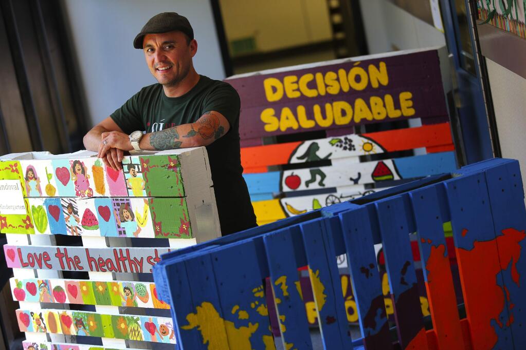 School parent Anastasio Tovar took the lead in organizing the Cesar Chavez Language Academy's float entry in this year's Rose Parade. Each of the school's twelve classes painted a palette to represent importing and exporting. Last year, the school's entry won first place for non-profit school.(Christopher Chung/ The Press Democrat)