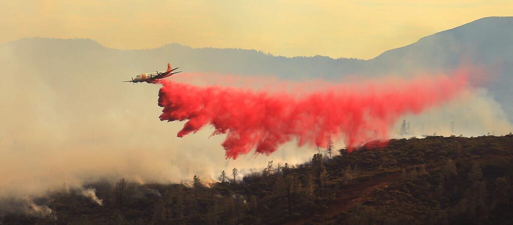 An air tanker makes a retardant drop on the head of the Jerusalem fire as it boils toward Knoxville-Berryessa Road in to Napa County, Monday Aug. 10, 2015. (Kent Porter / Press Democrat) 2015