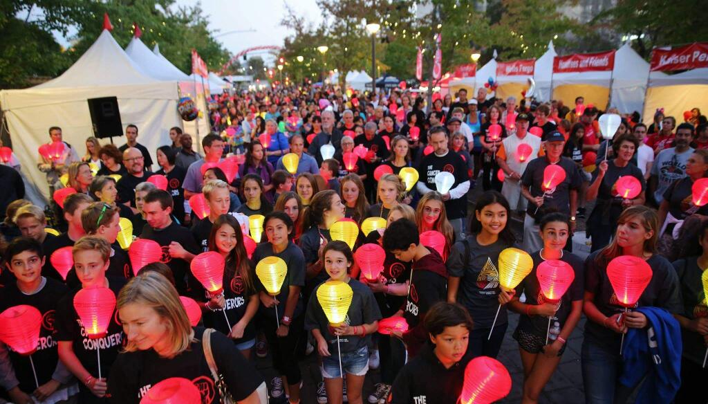 Co-workers, friends and families convened in downtown Santa Rosa for the Light The Night Walk and celebration. Walkers symbolically light the dark world of cancer by carrying illuminated lanterns: white for survivors, red for supporters and gold in memory of a loved one at the annual evening fundraiser for The Leukemia & Lymphoma Society. (photo by Will Bucquoy)