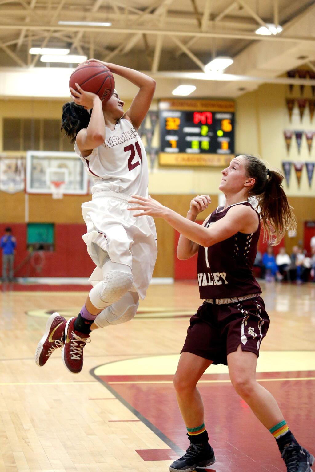 Cardinal Newman's Avery Cargill (21) reacts after being fouled on a drive to the basket by Scotts Valley's Nikiya Bechtle (1) during the first half of the CIF NorCal girls basketball playoff game on Saturday, March 12, 2016. (Alvin Jornada / The Press Democrat)