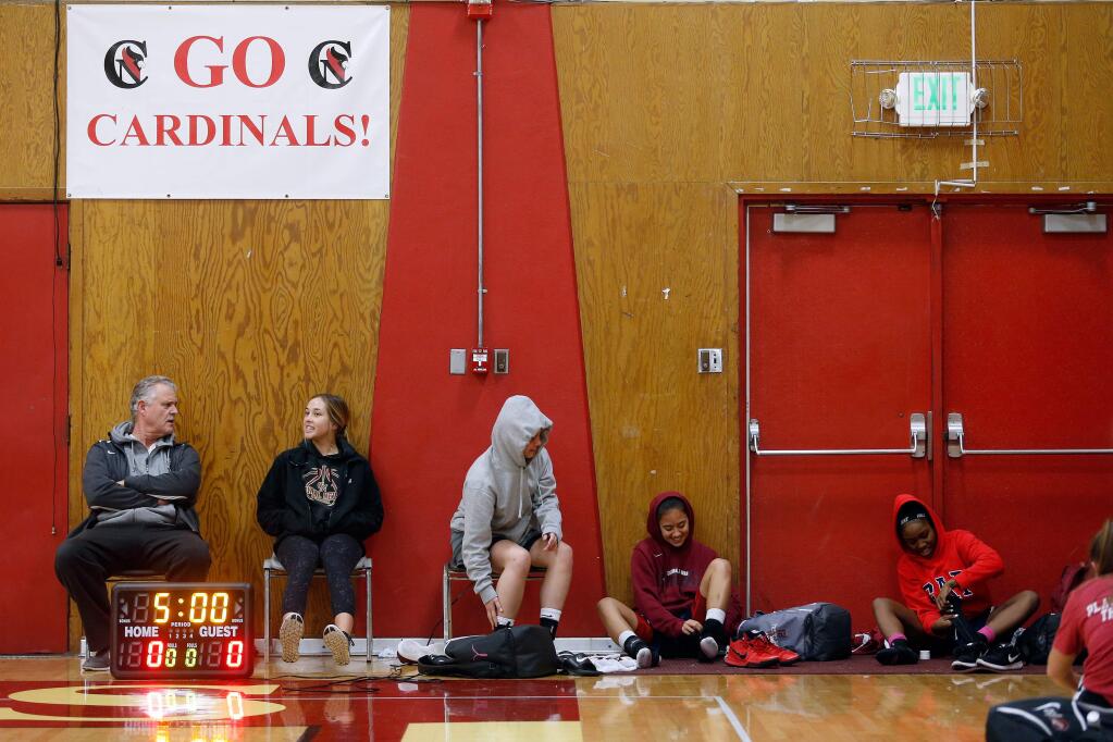 Cardinal Newman girls varsity basketball players and coaches get ready to practice in their home gym for the first time since the Tubbs Fire destroyed part of the school, at Cardinal Newman High School in Santa Rosa, California on Tuesday, January 16, 2018. (Alvin Jornada / The Press Democrat)