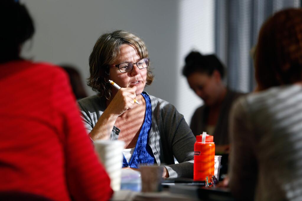 Fran Rasmus, works on a group activity with her classmates during a night class on special education laws, part of the teacher credentialing program by the Sonoma County Office of Education, in Santa Rosa, California on Thursday, September 29, 2016. Sonoma County currently fares better than other areas of California and the nation where there are serious shortages of teachers. (Alvin Jornada / The Press Democrat)