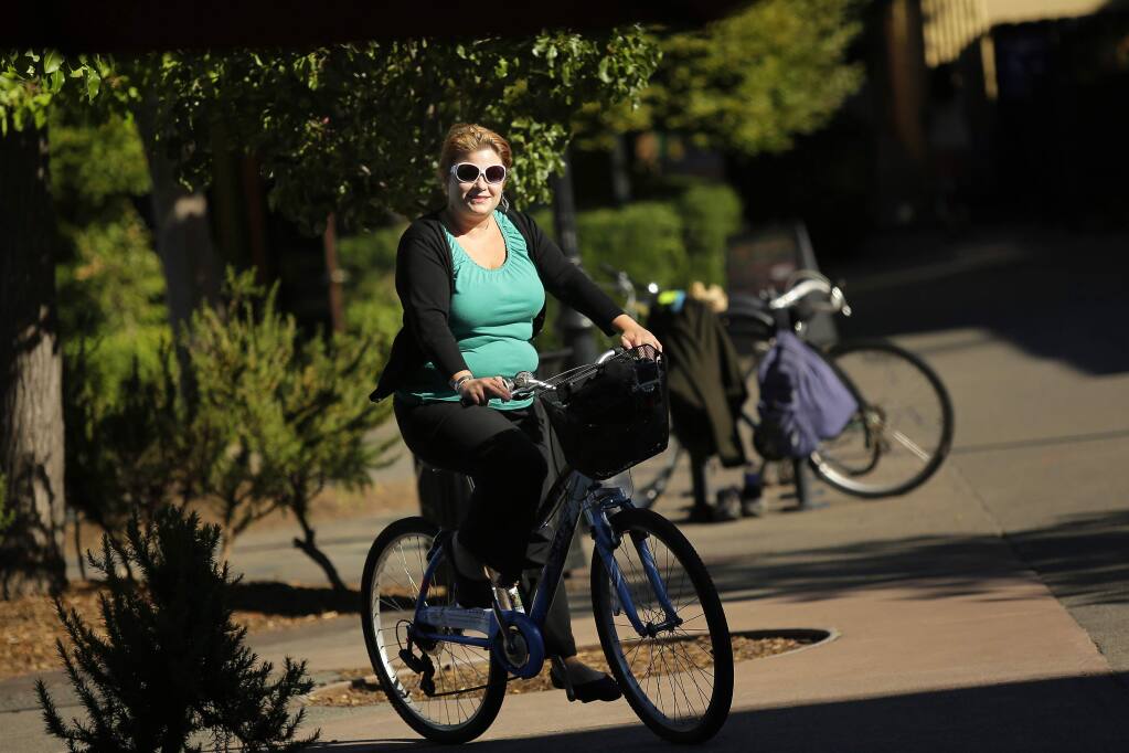 Sonoma County Bicycle Coalition Commuter of the Year, Liz Klaproth, rides home from work in downtown Sebastopol on Friday, July 11, 2014. Klaproth has rode her bike to work everyday for the past five years. (Conner Jay/The Press Democrat)
