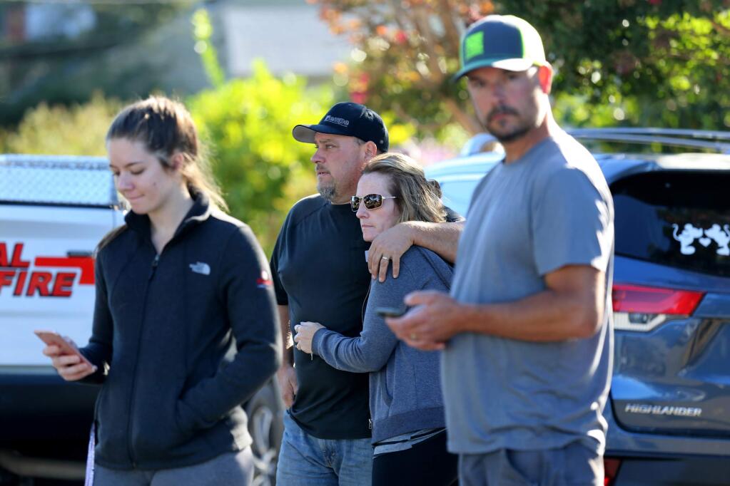 Brandon and Jessica Bayer, waiting for news of their son Andrew, 17, stand with student Jackelyn Strange, 17, left, and parent Blair Benson, right, as Santa Rosa police search the campus of Ridgway High School in Santa Rosa on Tuesday, October 22, 2019. (BETH SCHLANKER/ The Press Democrat)