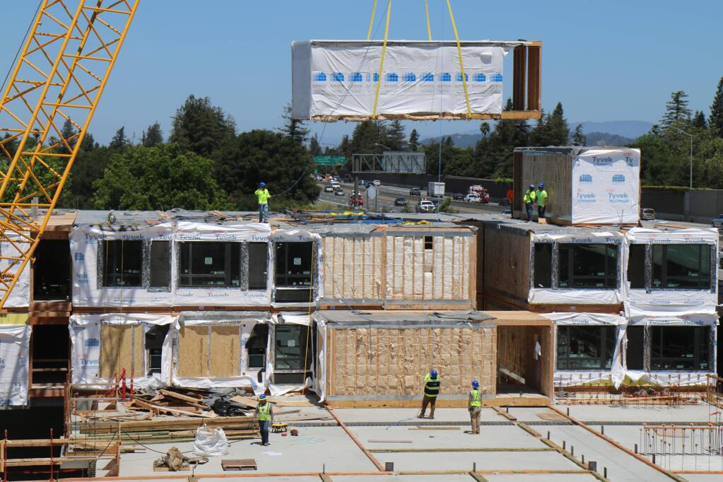 A two-room module built in Idaho is lowered into position on Tuesday, June 18, 2019, at the AC Hotel project next to Highway 101 in downtown Santa Rosa. (Jeff Quackenbush / North Bay Business Journal)