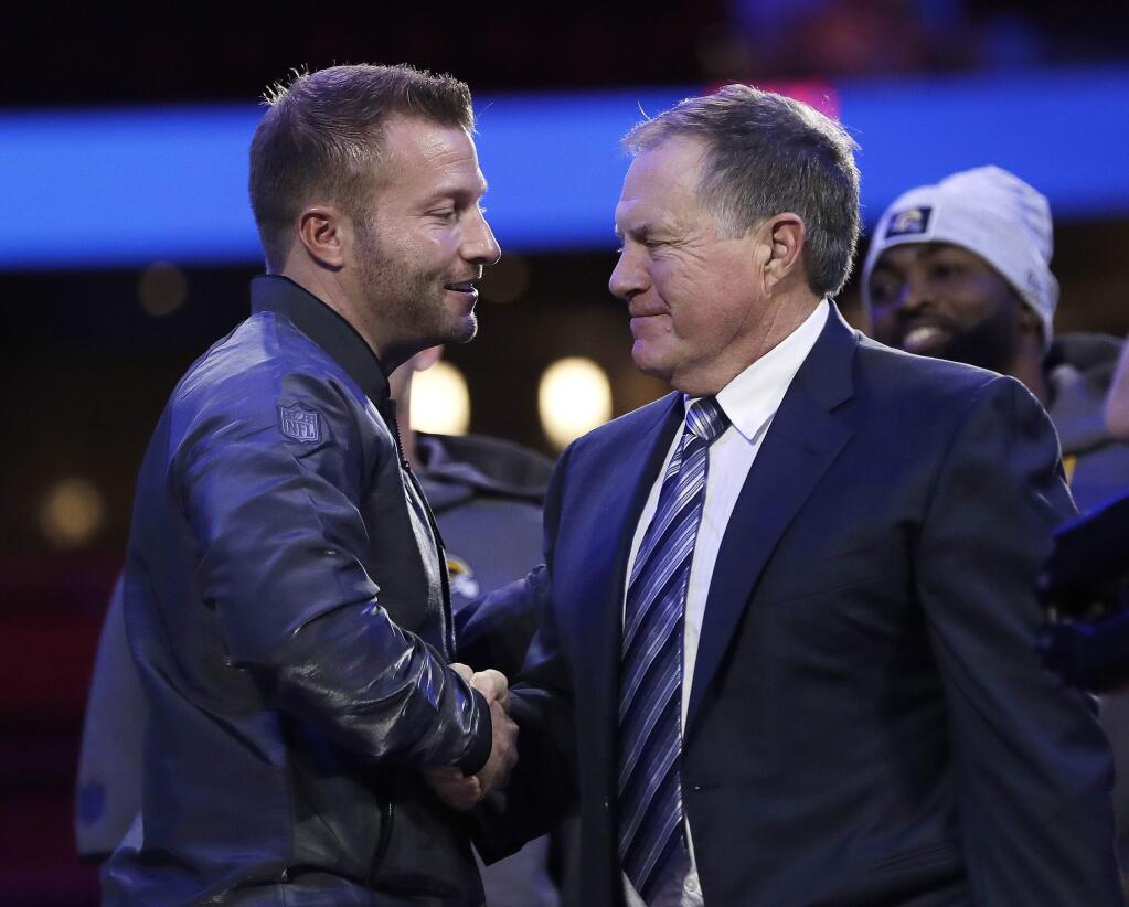 Los Angeles Rams head coach Sean McVay, left, shakes hands with New England Patriots head coach Bill Belichick during Opening Night for the NFL Super Bowl 53 football game Monday, Jan. 28, 2019, in Atlanta. (AP Photo/David J. Phillip)