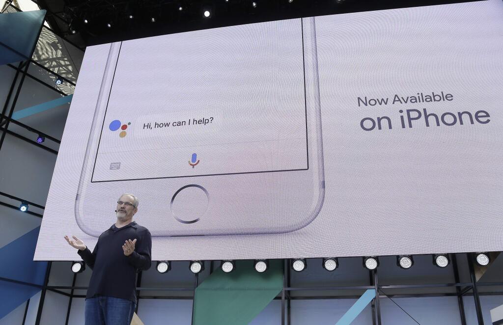 Scott Huffman talks about the Google Assistant now being available on the Apple iPhone during the keynote address of the Google I/O conference, Wednesday, May 17, 2017, in Mountain View, Calif. (AP Photo/Eric Risberg)