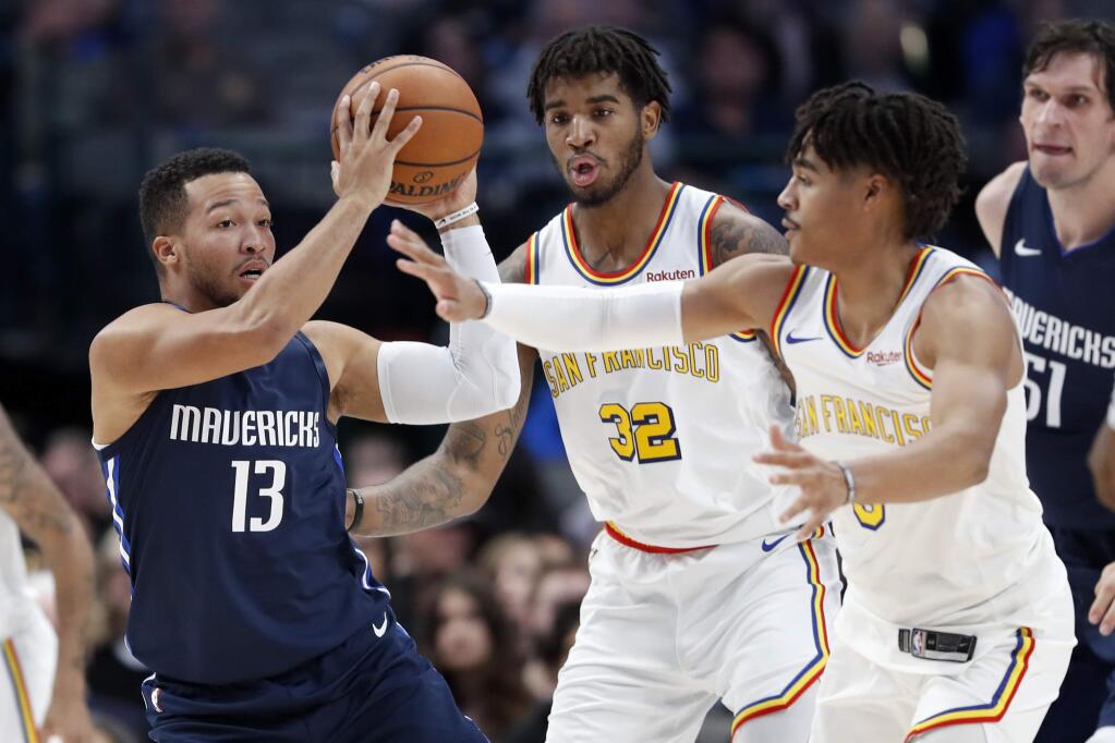 Dallas Mavericks guard Jalen Brunson (13) looks to make a pass as Golden State Warriors' Marquese Chriss (32) and Jordan Poole, right, defend in the first half of an NBA basketball game in Dallas, Wednesday, Nov. 20, 2019. (AP Photo/Tony Gutierrez)