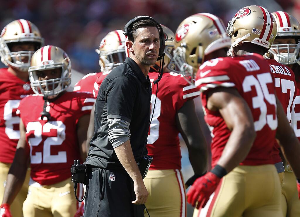 In this Sunday, Sept. 10, 2017, file photo, San Francisco 49ers head coach Kyle Shanahan, center, watches during the second half against the Carolina Panthers in Santa Clara. (AP Photo/Tony Avelar, File)